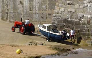 A fishing vessel is recovered by tractor
