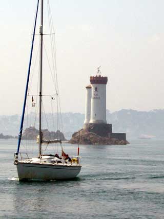 A yacht passes the distinctive La Croix lighthouse