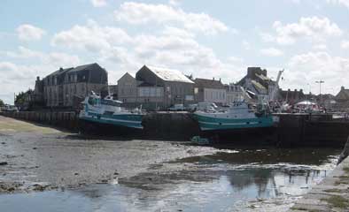 St Vaast fishing boats near the entrance lock at low water
