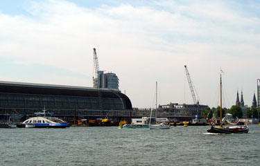 Yachts and motor boats dodge the Amsterdam ferry leaving Central Station
