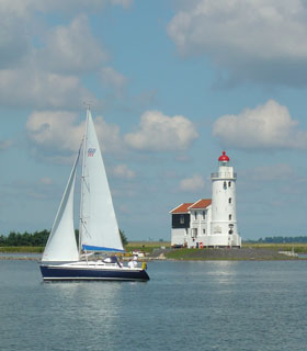 Just enough wind for a yacht sailing past Marken lighthouse