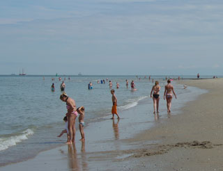 Bathers enjoy the sandy beach on Vlieland
