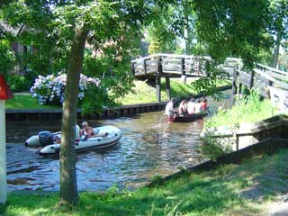 Take the dinghy through Giethoorn's tiny dorpsgracht (village canal)