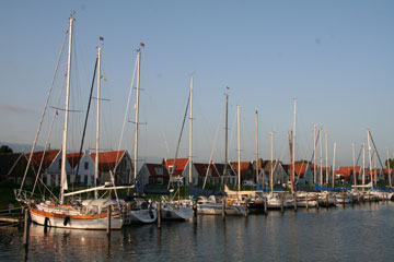 Traditional wooden houses lkine the harbour at Durgerdam