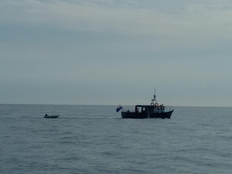 Cruising past English Channel swimmers at sea