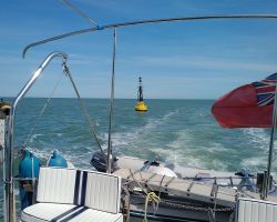 Lady Martina crossing the Thames Estuary out at sea and passing Long Sand Head North Cardinal Marker